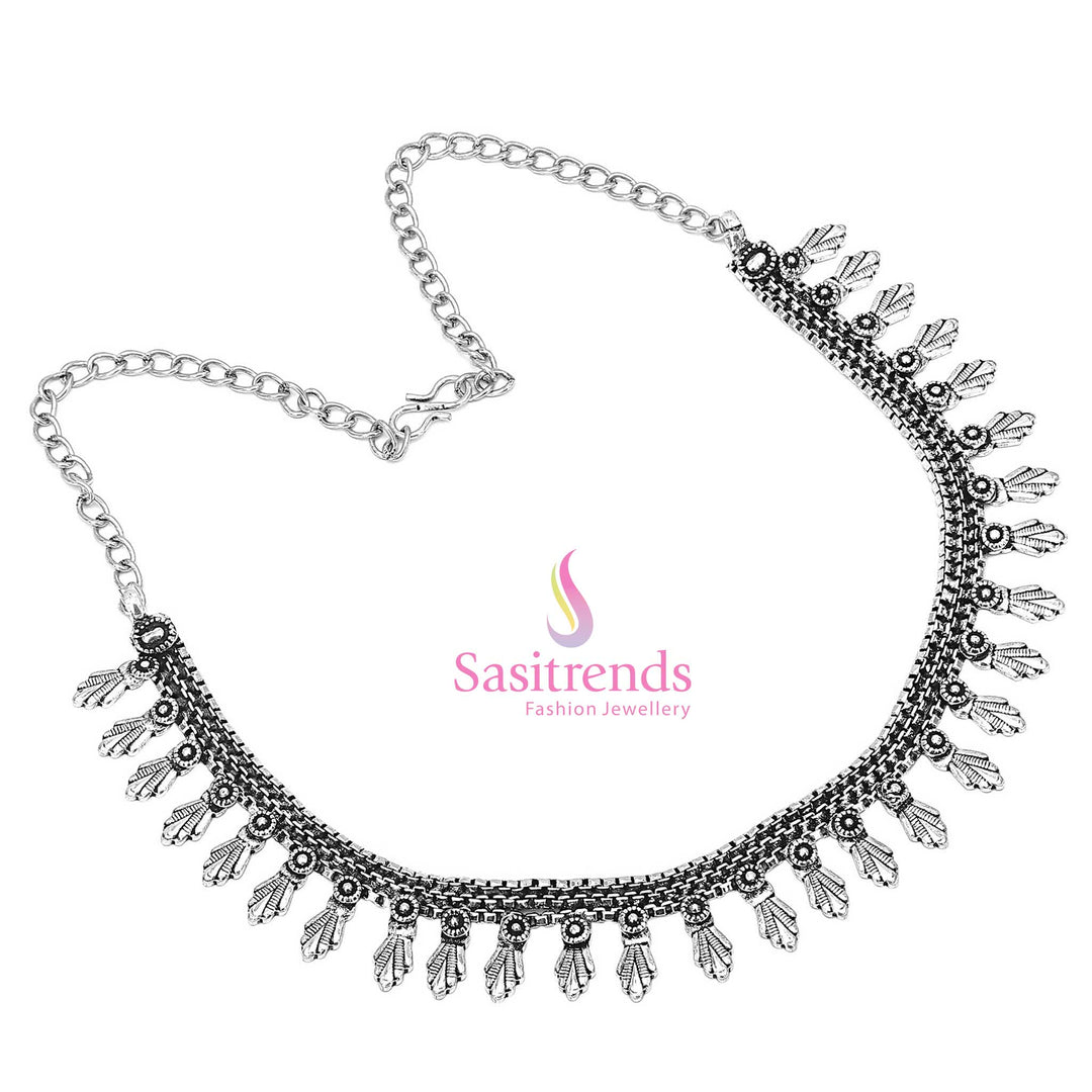 Divine river of antique artistry flows through this oxidised tribal necklace, with a spiral centre embraced by curvy floral motifs – a sacred jewellery piece – Sasitrends