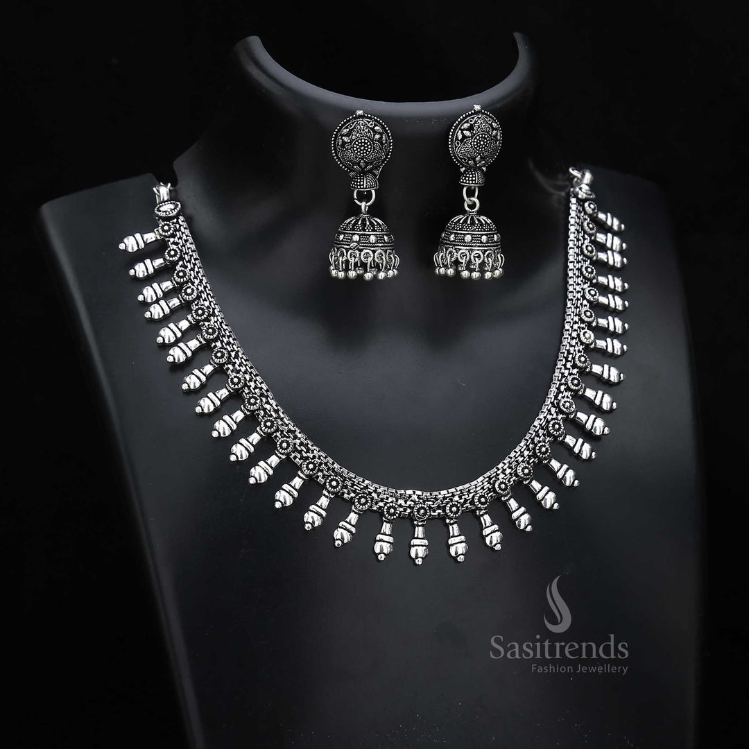 Artisan finish oxidised silver jewellery set with bell-shaped jhumkas and ornate texturing – suited for cultural occasion wear with traditional depth – Sasitrends