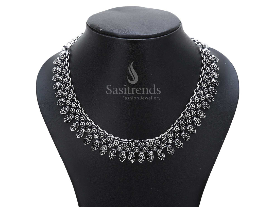 Earthborn heritage defines this oxidised silver necklace with temple bell drops and a beautifully carved lotus motif – a traditional ancestral jewellery piece – Sasitrends