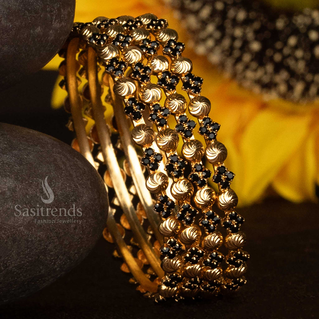 Elegant spiral bangles with bold black stones and glossy micro gold plating – crafted with a one gram finish that mimics real gold, perfect for ethnic wear and special occasions – Sasitrends
