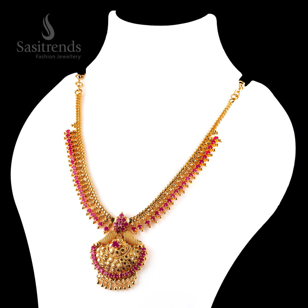 Timeless lustrous micro gold plated ruby tilak pendant necklace featuring exquisite traditional carvings and golden details - Sasitrends