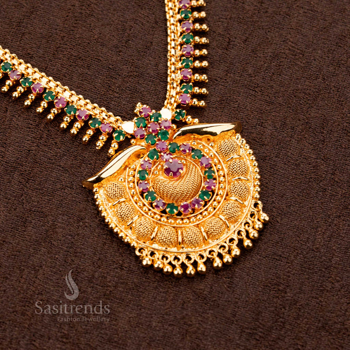 Elegant majestic micro gold plated ruby Green AD tilak pendant royal necklace, designed with sparkling stones and golden ball detailing - Sasitrends