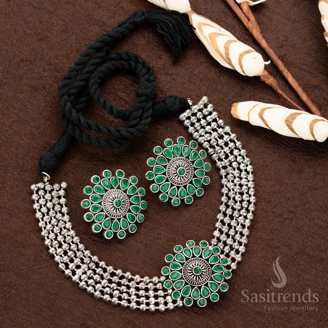 Stylish oxidised German silver choker set with a floral green stone-studded pendant, crafted with four layers of beads, enhancing Navaratri and festive traditional wear with grace and charm - Sasitrends