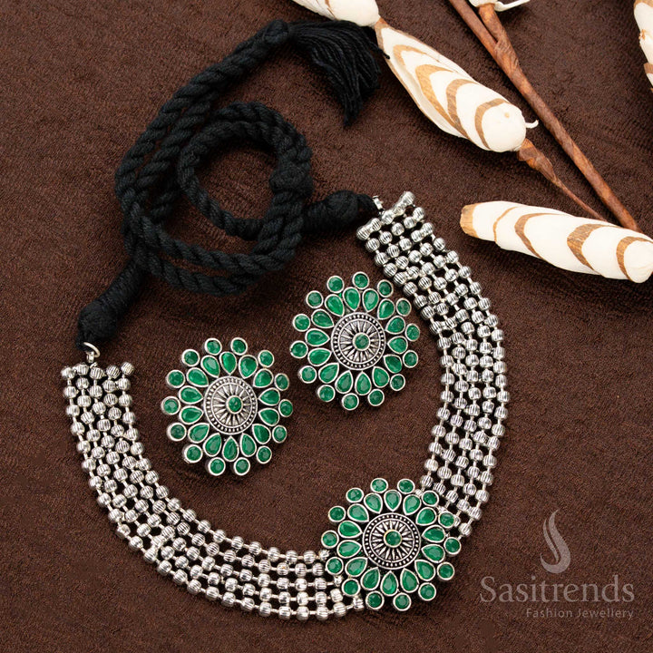 Stylish oxidised German silver choker set with a floral green stone-studded pendant, crafted with four layers of beads, enhancing Navaratri and festive traditional wear with grace and charm - Sasitrends