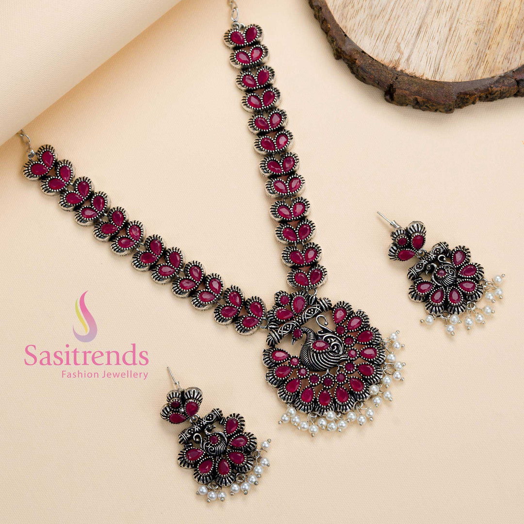 Oxidised ruby stone peacock pendant set paired with lustrous pearls and earrings, a festive-glam creation with a touch of ethnic tradition – Sasitrends