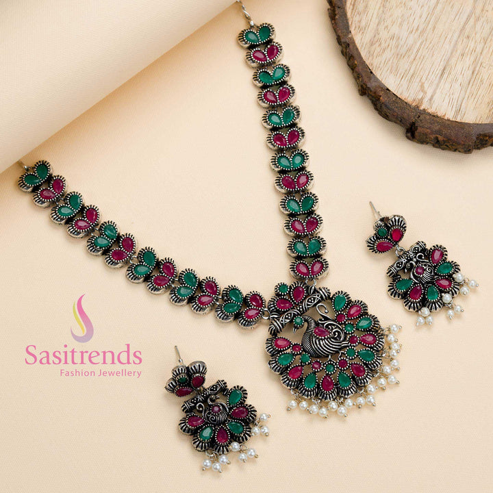 Oxidised peacock pendant jewellery set in ruby-green stones with delicate pearl drops, blending heritage detailing with festive fusion elegance – Sasitrends