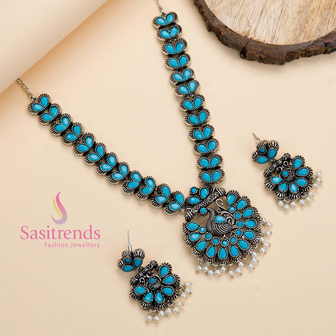 Sky-blue stone oxidised peacock pendant necklace with pearl details, a traditional party jewellery piece radiating a refreshing aura – Sasitrends