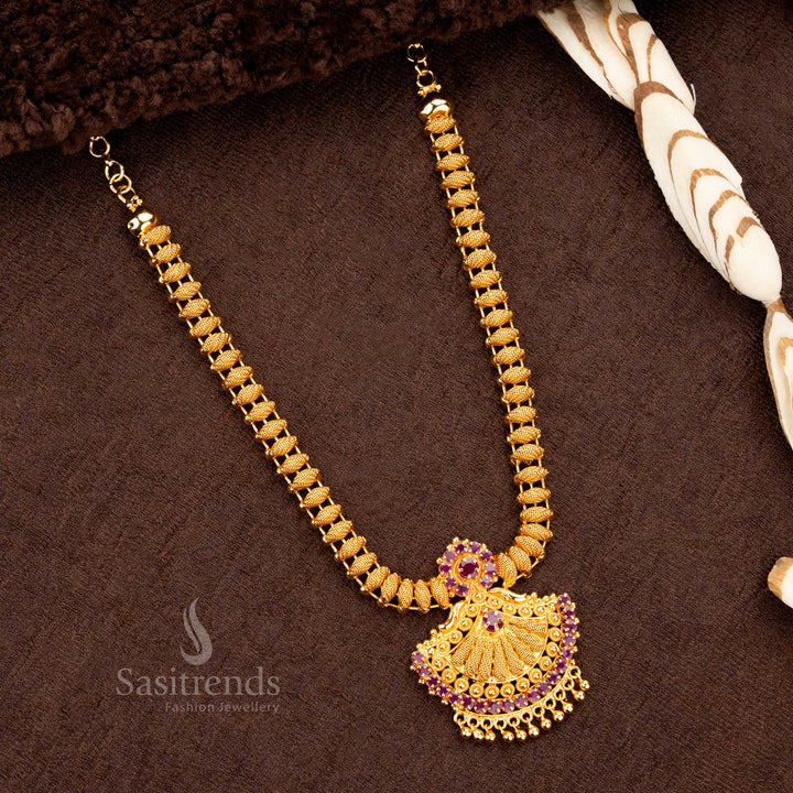 Majestic and regal 1-gram micro gold-plated necklace with a uniquely designed Tilak-shaped pendant, studded with dazzling ruby AD stones - Sasitrends