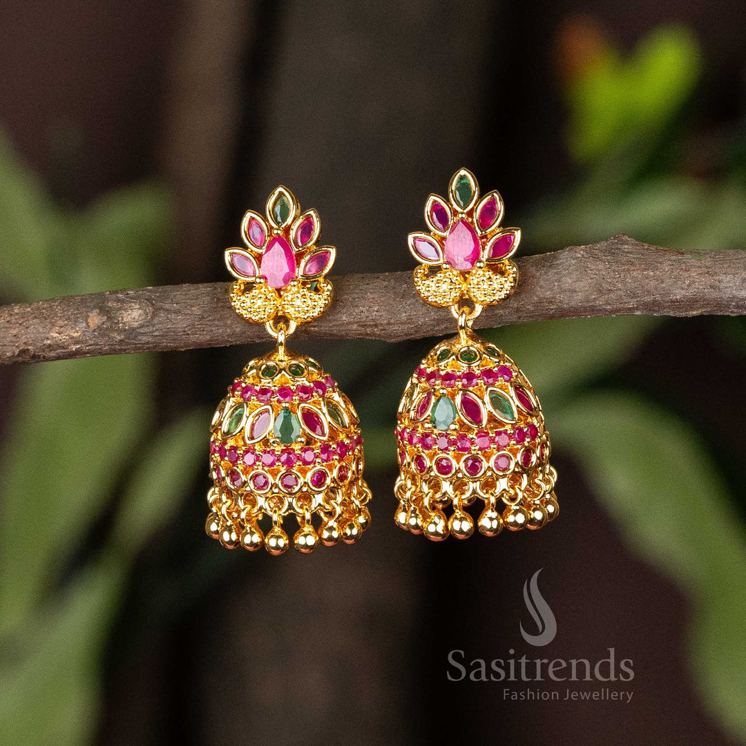 Rich ruby-green micro gold plated traditional jhumkas with sparkling AD stones and classic pearl hangings – A timeless temple-inspired design with a touch of modern opulence – Sasitrends