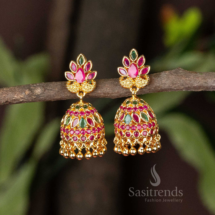 Rich ruby-green micro gold plated traditional jhumkas with sparkling AD stones and classic pearl hangings – A timeless temple-inspired design with a touch of modern opulence – Sasitrends