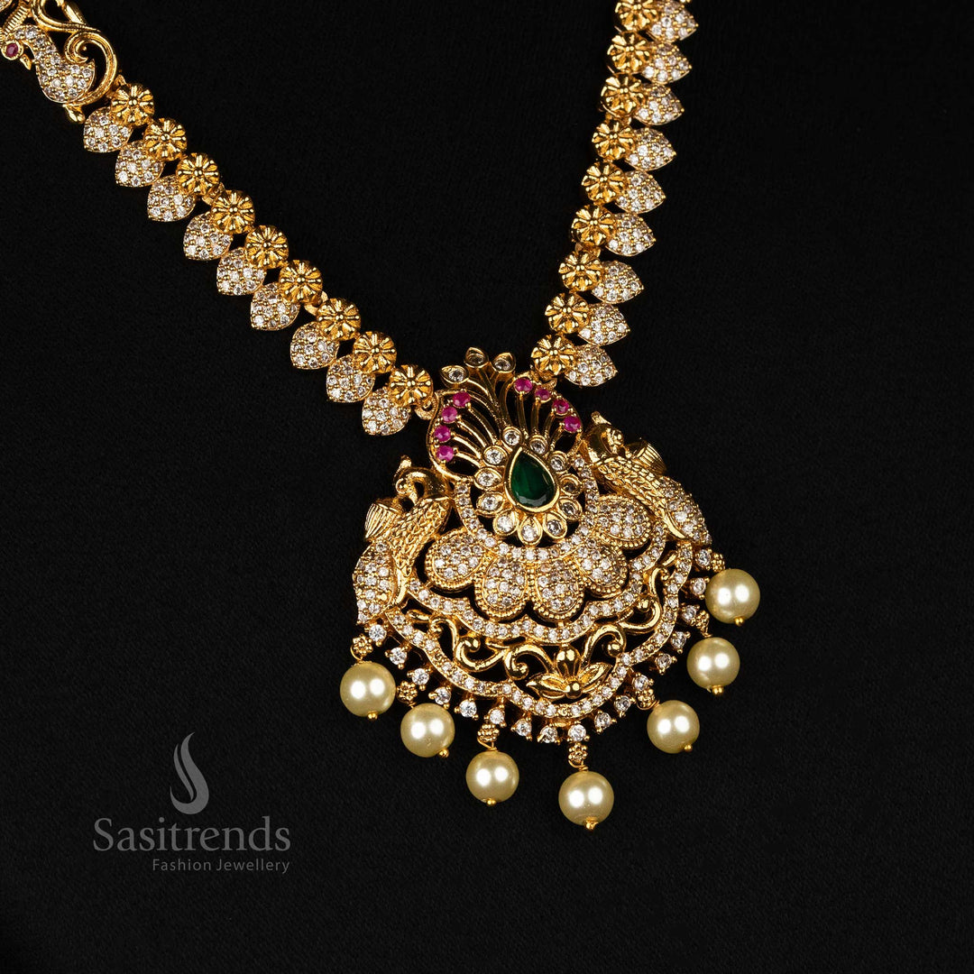 Sophisticated Premium Temple Bridal Jewellery Set with Matte Gold Finish, Peacock Motifs, American Diamonds, and Hanging Pearls
These sets offer detailed, distinctive names and alt tags for the jewellery set, optimized for search engine results, and provide a comprehensive description for each piece - Sasitrends