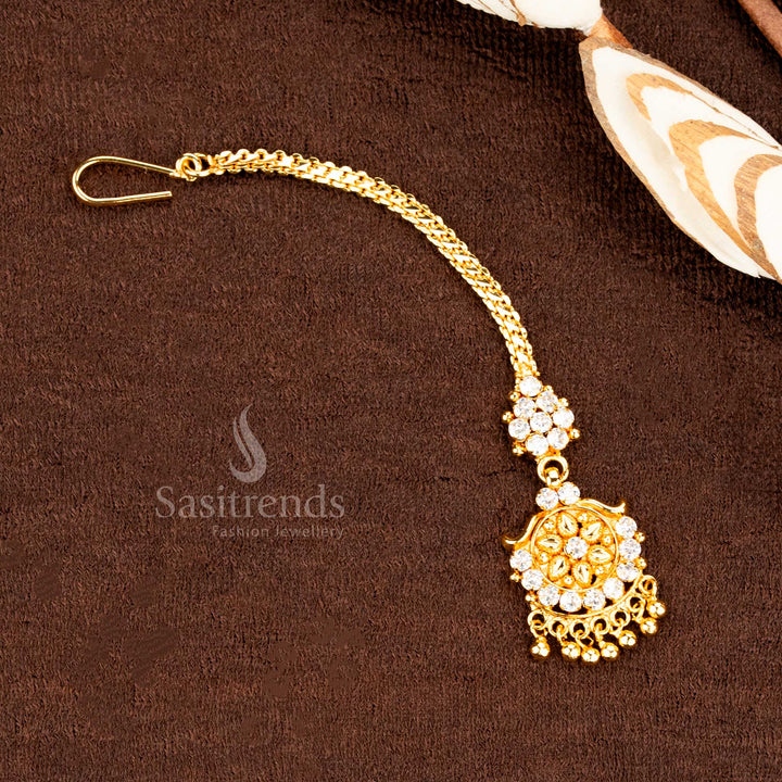 Graceful micro gold plated traditional white AD stone floral tikka with hanging ball drop design, crafted as elegant bridal head jewellery for ethnic ensembles and wedding moments – sasitrends