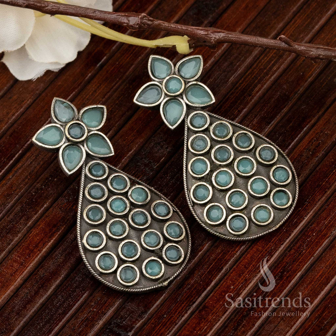 Elegant oxidised earrings featuring mint-coloured pear stones with a textured base, showcasing dainty antique vibes perfect for festive jewellery styling – Sasitrends