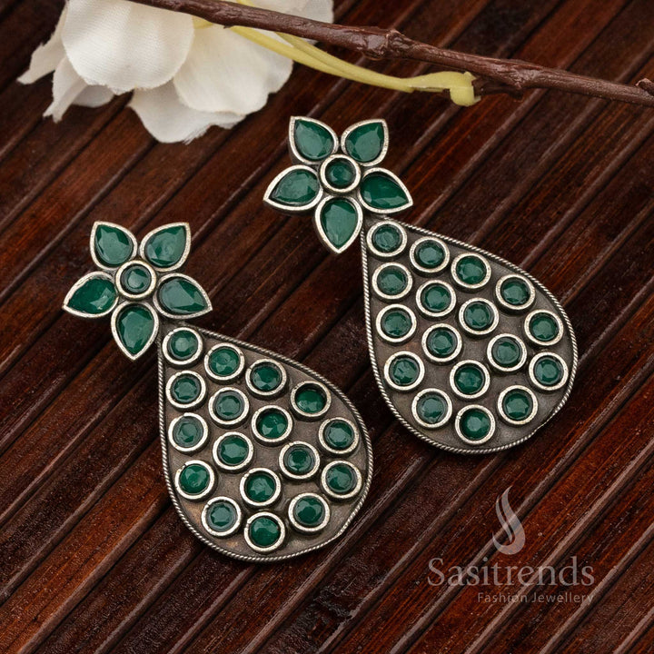 Traditional pear-shaped oxidised earrings with engraved green gemstone and leaf patterns, carrying temple-inspired divine jewellery artistry – Sasitrends