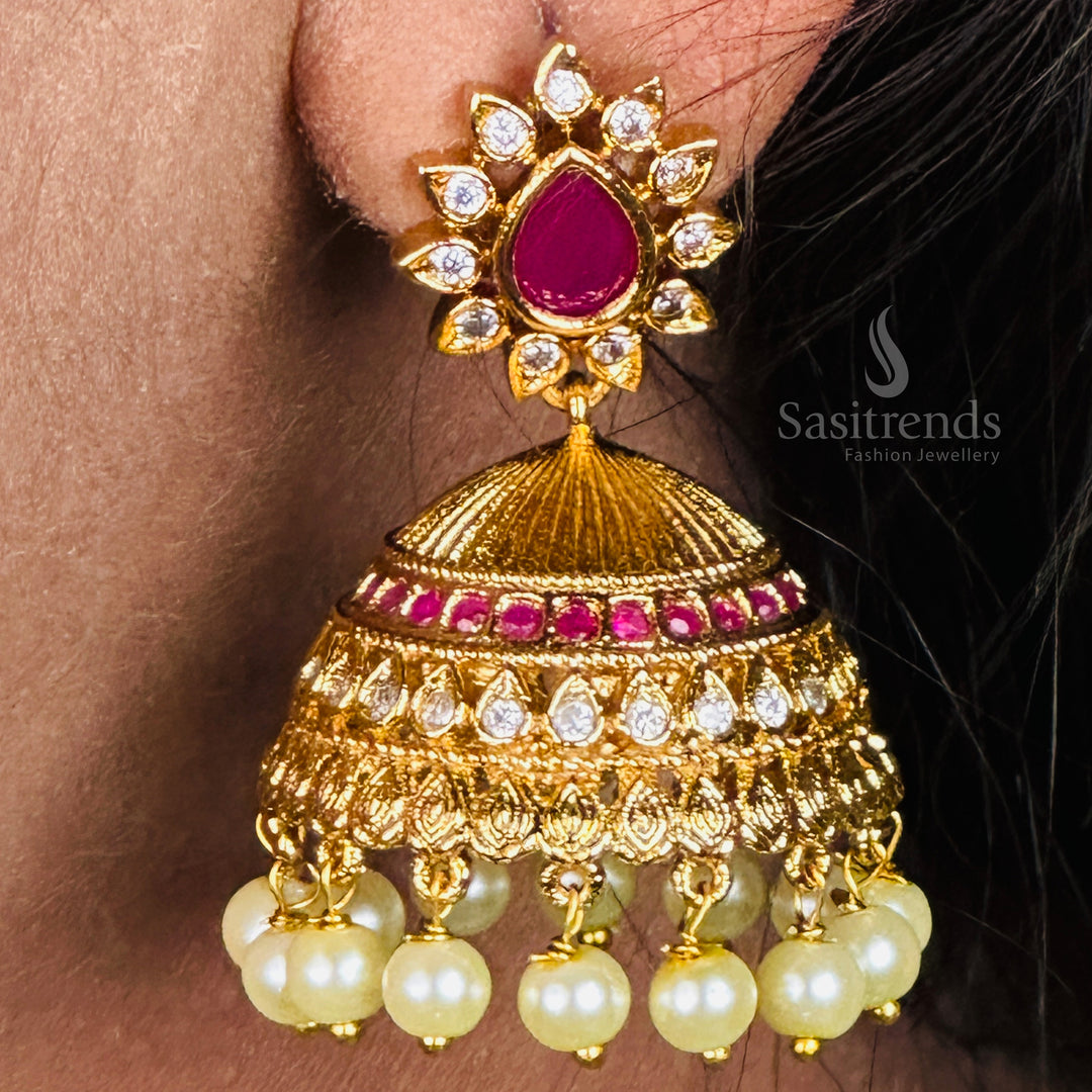 Traditional pearl jhumka earrings featuring temple matte gold finish and AD accents, perfect for elegant festive jewellery occasions - Sasitrends
