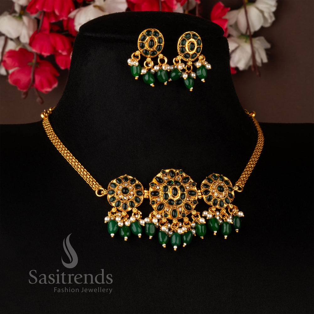 Stunning temple-style floral choker necklace set in matte gold, featuring dazzling green American diamonds, designed with a traditional touch and complemented by matching earrings - Sasitrends