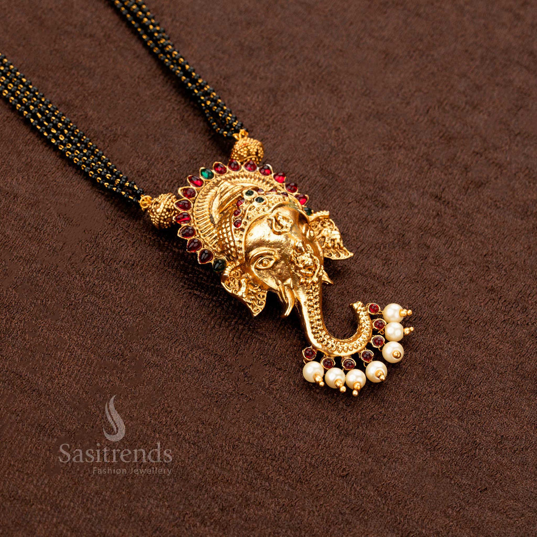 Classic South Indian-style Ganesha mangalsutra in matte gold finish with ruby-green gemstone floral motifs, an elegant and symbolic bridal jewellery design - Sasitrends