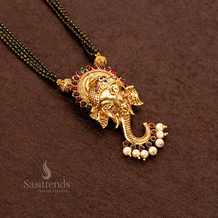 Classic South Indian-style Ganesha mangalsutra in matte gold finish with ruby-green gemstone floral motifs, an elegant and symbolic bridal jewellery design - Sasitrends