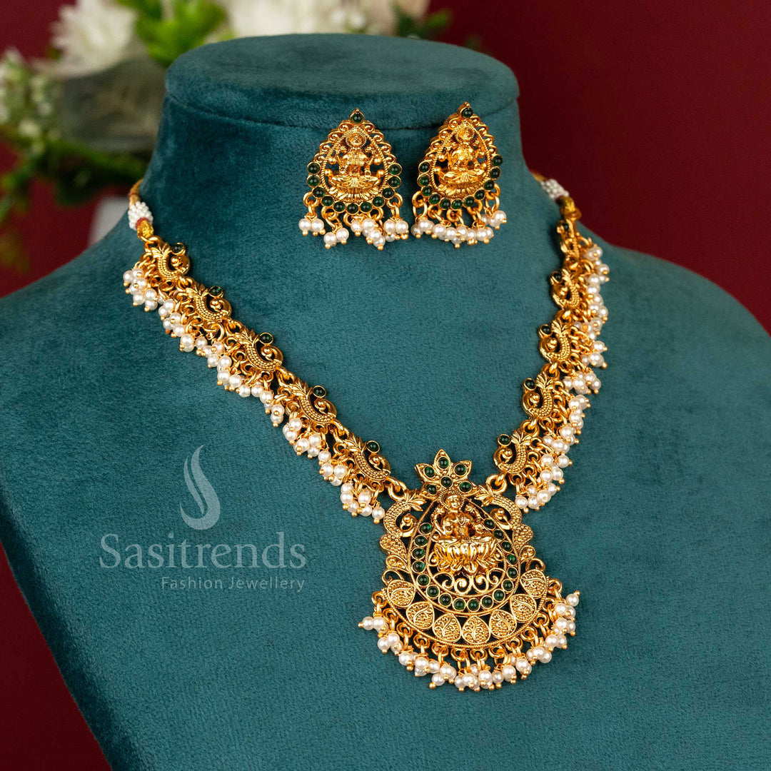 Majestic matte gold-plated temple Lakshmi peacock necklace set, featuring an emerald-hued green radiance, a divine statement of heritage and festive jewellery grandeur - Sasitrends