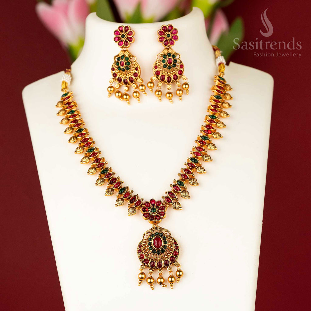 Ornate matte finish gold temple floral necklace jewellery set, featuring a striking blend of ruby-green stones, a perfect fusion of cultural artistry and royal elegance - Sasitrends