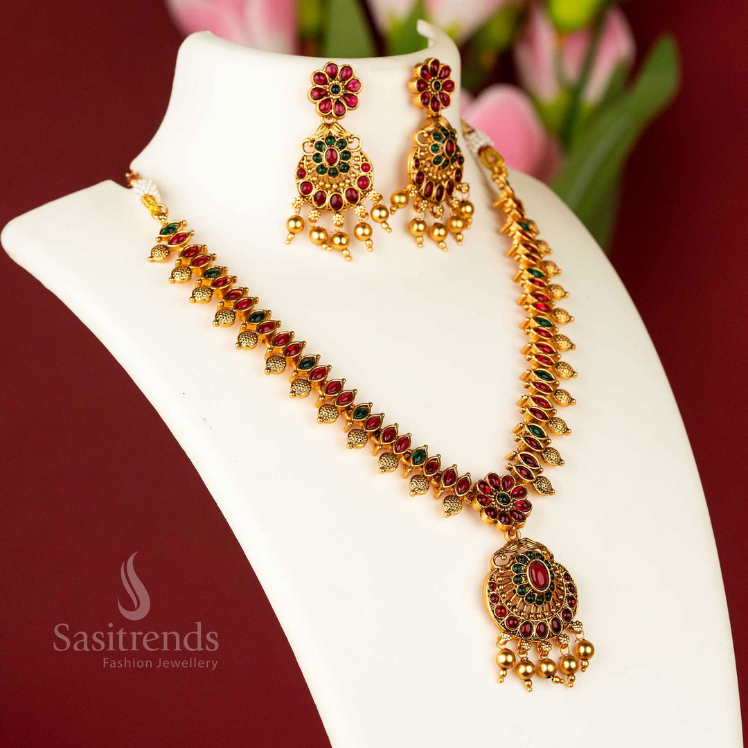 Majestic matte gold plated temple flower designer necklace jewellery set, intricately designed with ruby and green stones, a true masterpiece of traditional craftsmanship - Sasitrends