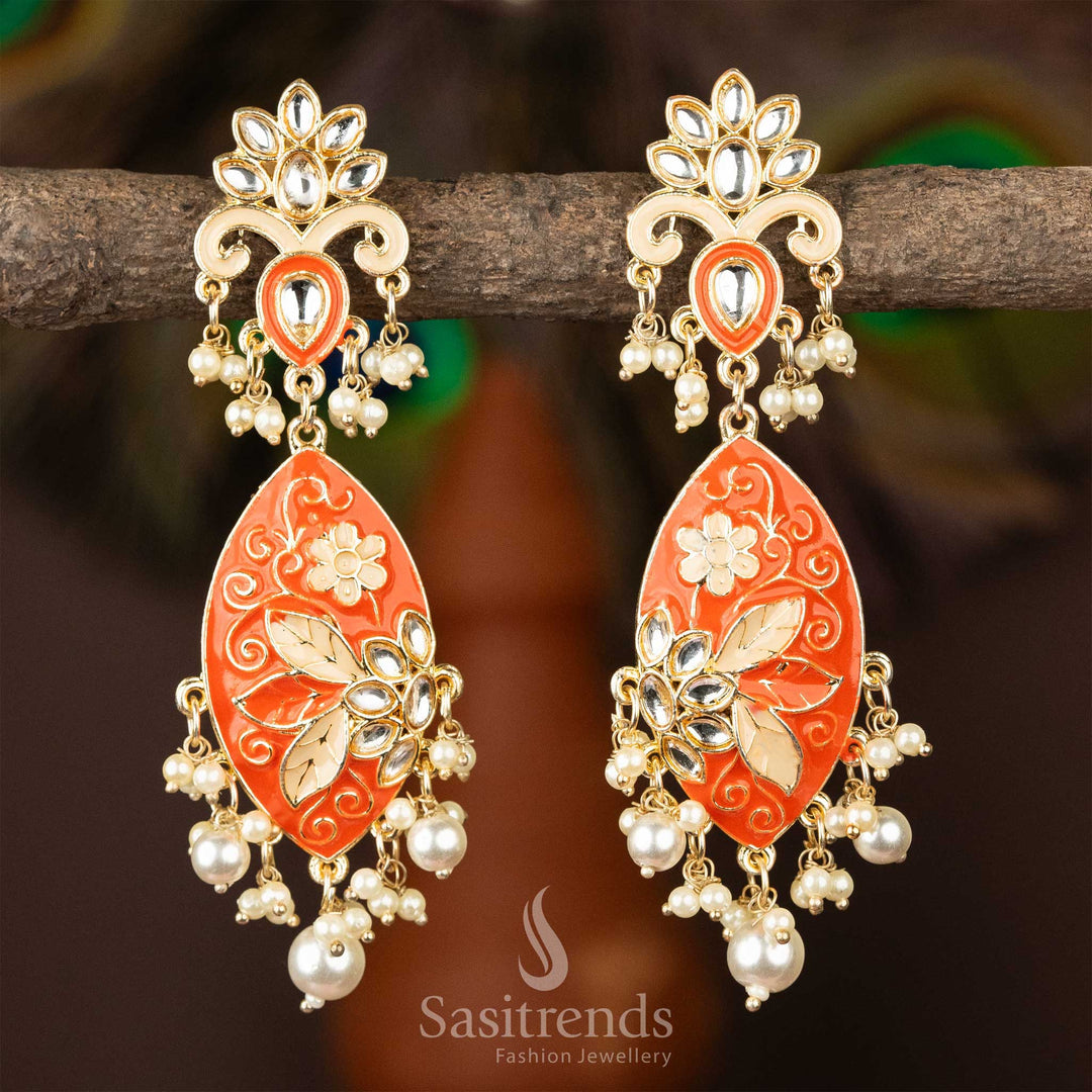 Regal red enamel and pearl embellished gold-plated kundan earrings.