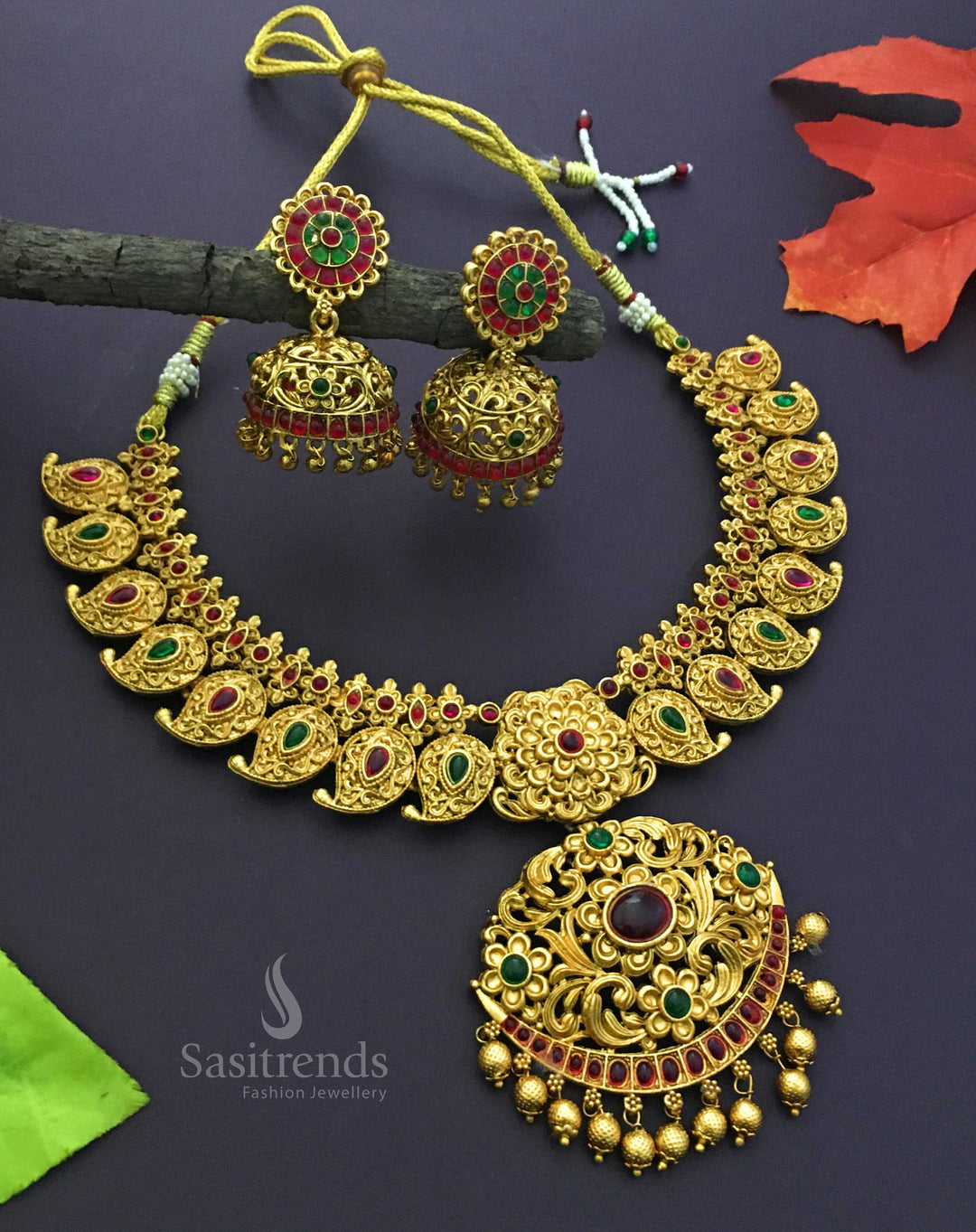 Temple-style matte gold plated jewellery set featuring the iconic mango motif, glowing with ceremonial sheen, heritage beauty, and exquisite ethnic detailing by Sasitrends