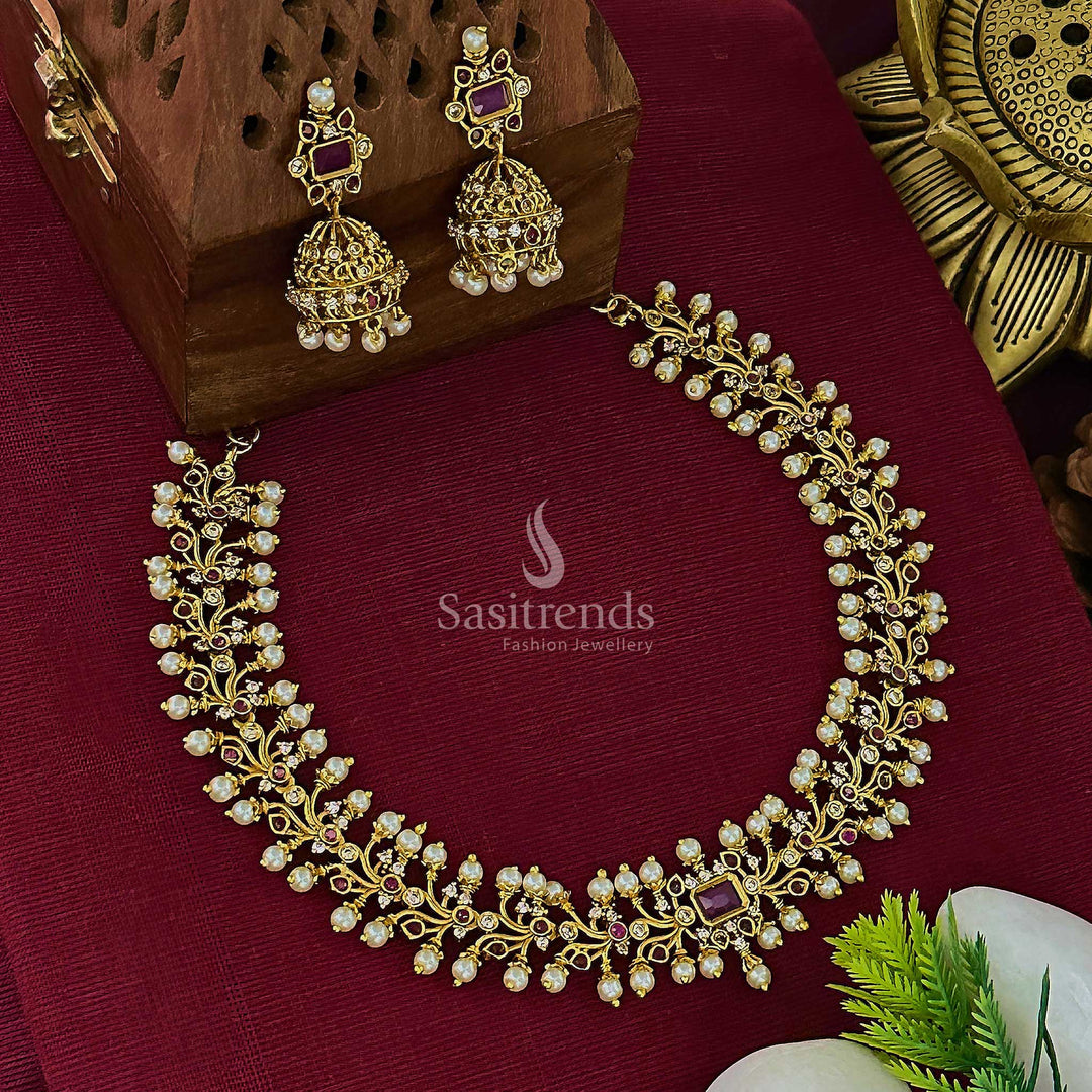 Grand temple matte gold plated floral choker jewellery set with centre ruby kemp stone and matching jhumkas, ideal for bridal festivities and cultural elegance – Sasitrends
