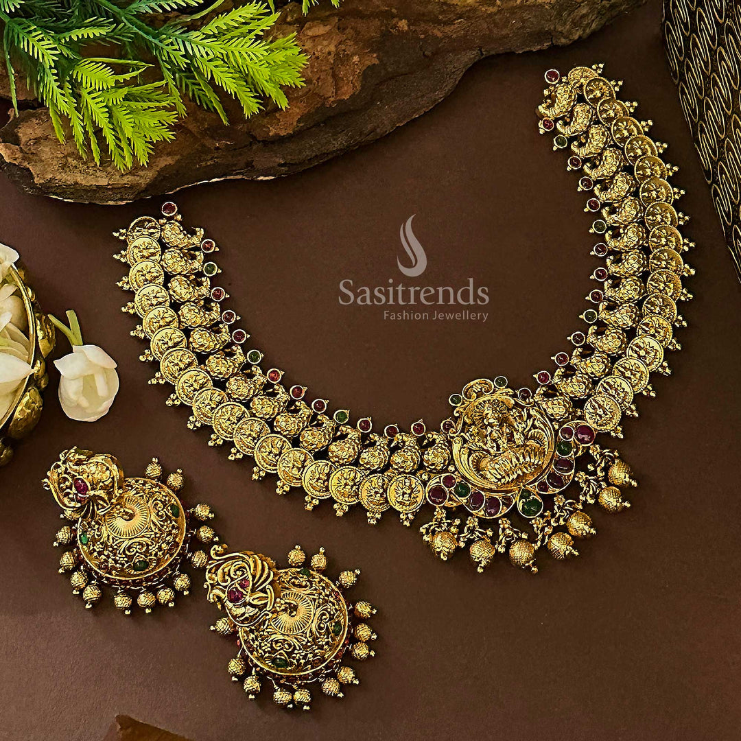 Traditional bridal Lakshmi and peacock jewellery set in temple matte gold with ruby-green kemp stones and delicate jhumkas, crafted to complete festive elegance and spiritual splendour – Sasitrends