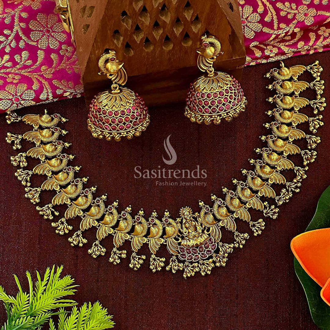 Temple matte gold traditional bridal Lakshmi peacock jewellery set with ruby kemp stone pendant and classic jhumka earrings, curated for a grand wedding look and traditional richness – Sasitrends