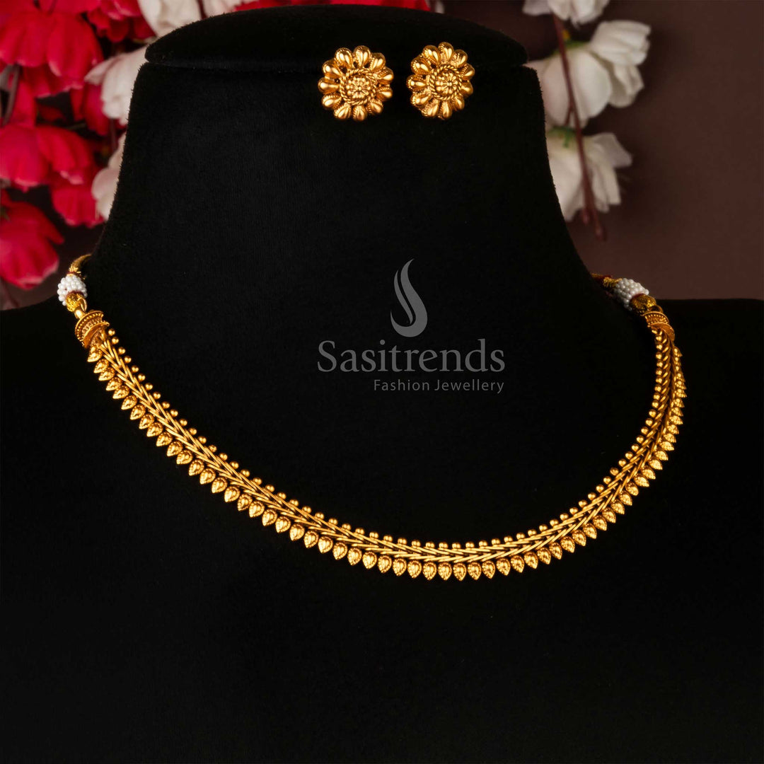 Antique gold-plated leaf-patterned necklace and flower stud earrings set on a black display - Sasitrends