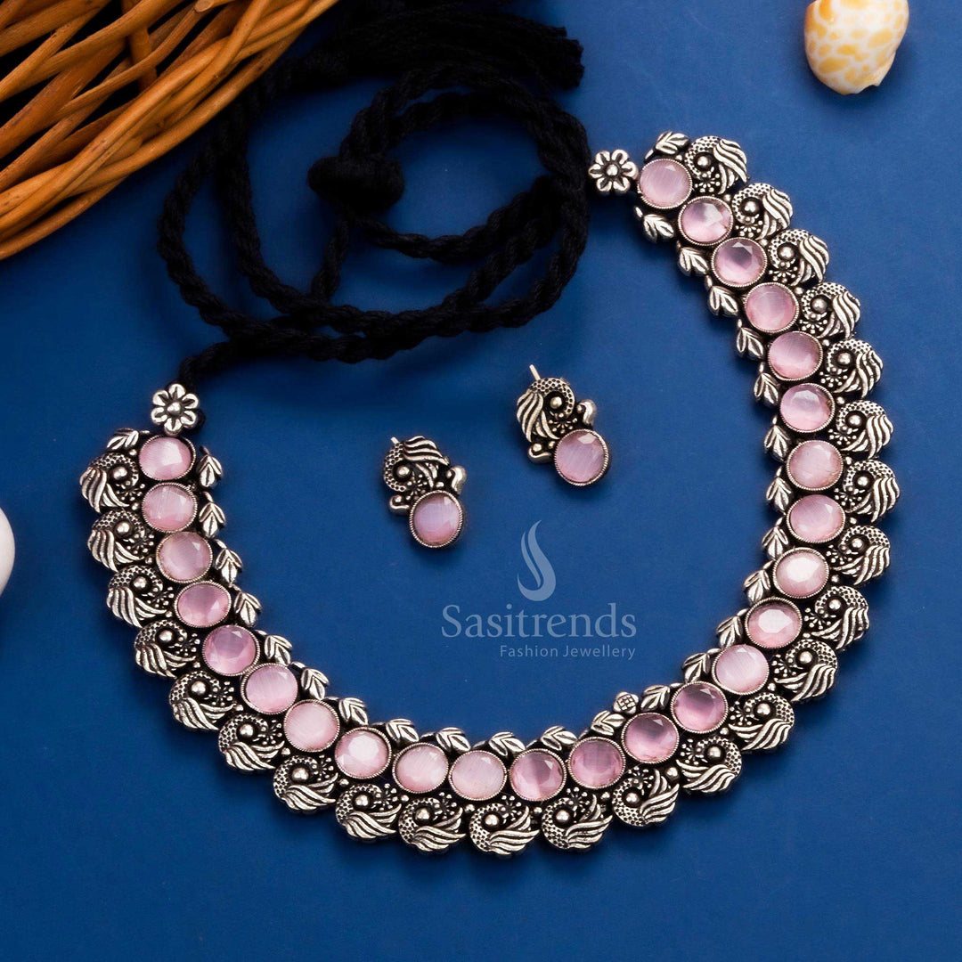 Luxurious antique peacock Kushi oxidised necklace set showcasing bold pink stones and intricate peacock earrings, a royal addition to festive jewellery - Sasitrends