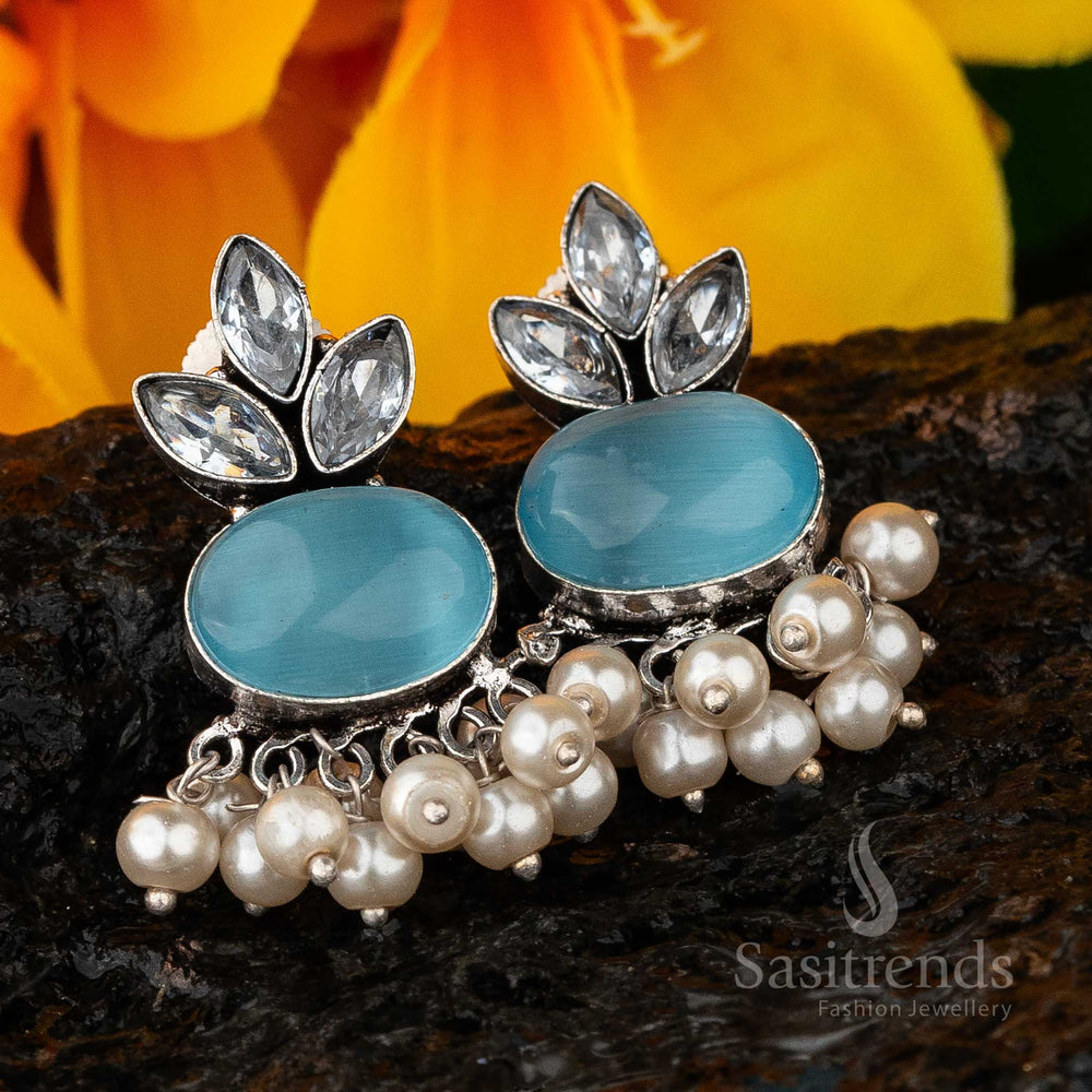 Chic blue oxidised silver-look earrings embellished with Monalisa stones, AD highlights and a graceful pearl drop – a trendy statement jewellery piece – Sasitrends