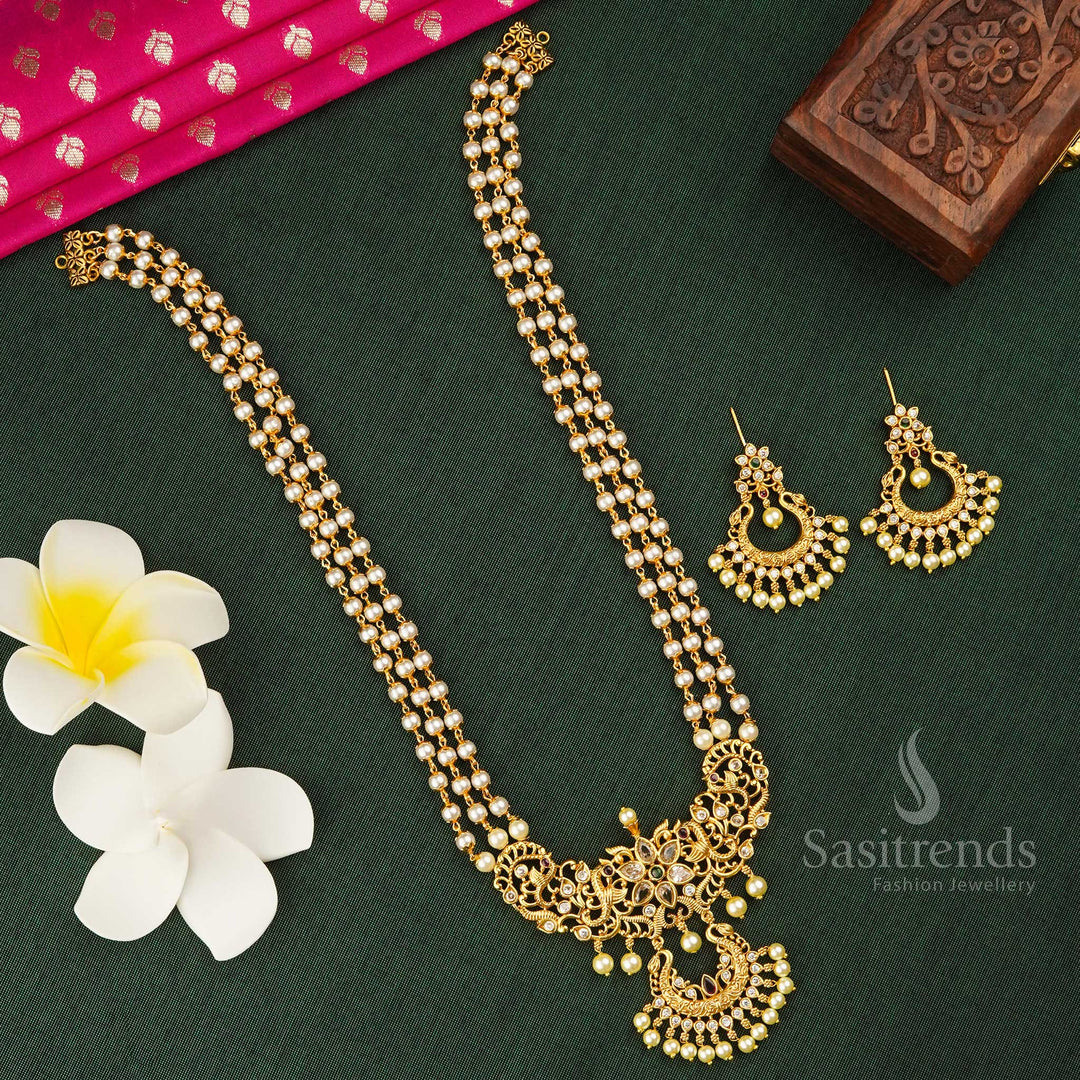 Elegant three-layer pearl mala long jewellery set in matte gold finish with a dazzling American Diamond pendant – a timeless ethnic treasure tailored for silk saree styling, religious rituals, and temple-inspired bridal looks – Sasitrends