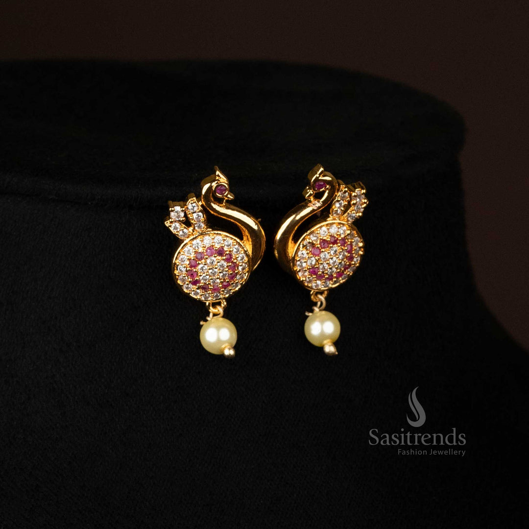 Zoomed-in shot of earrings featuring peacock design and pearl drops - Sasitrends