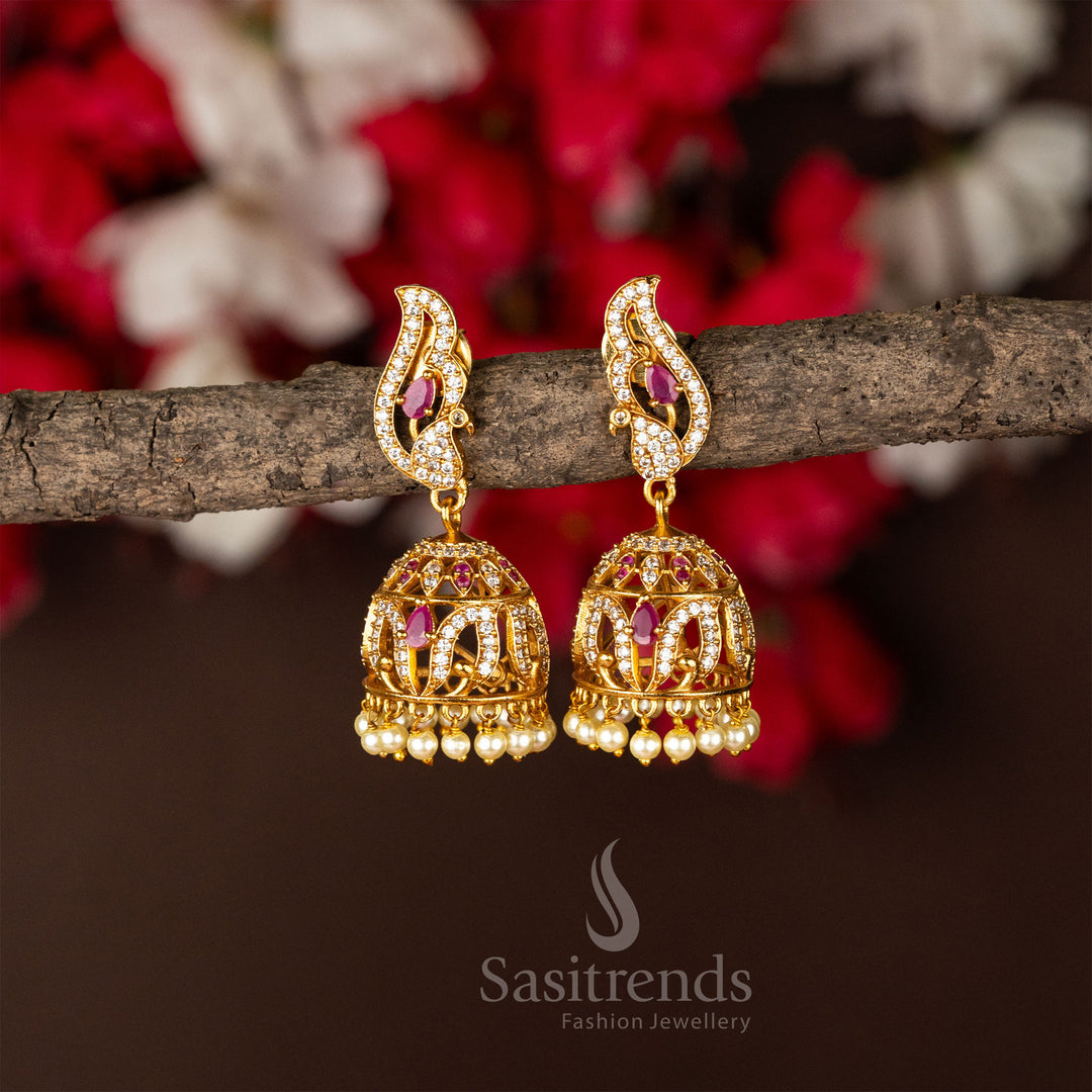 Exquisite temple matte gold plated peacock jhumka earrings in white-ruby tones, showcasing intricate temple artistry and traditional jewellery details - Sasitrends