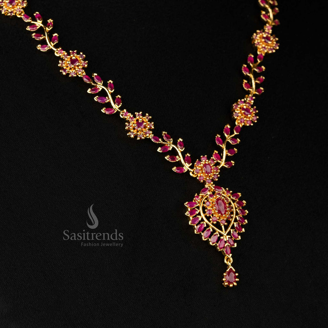 Detailed view of ruby accents on the micro gold-plated floral motif pendant - Sasitrends