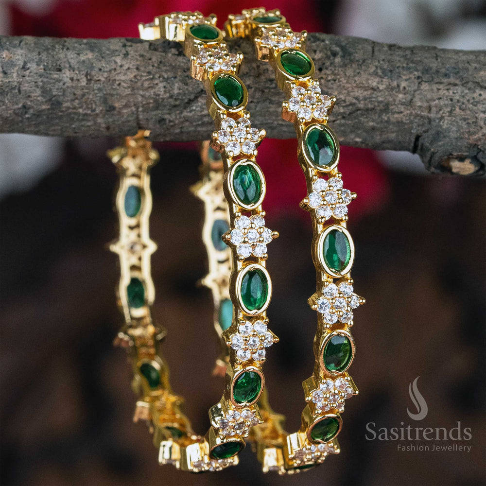 Ethnic white and emerald green stone-studded gold plated floral design bangles pair with dazzling diamond accents - Sasitrends