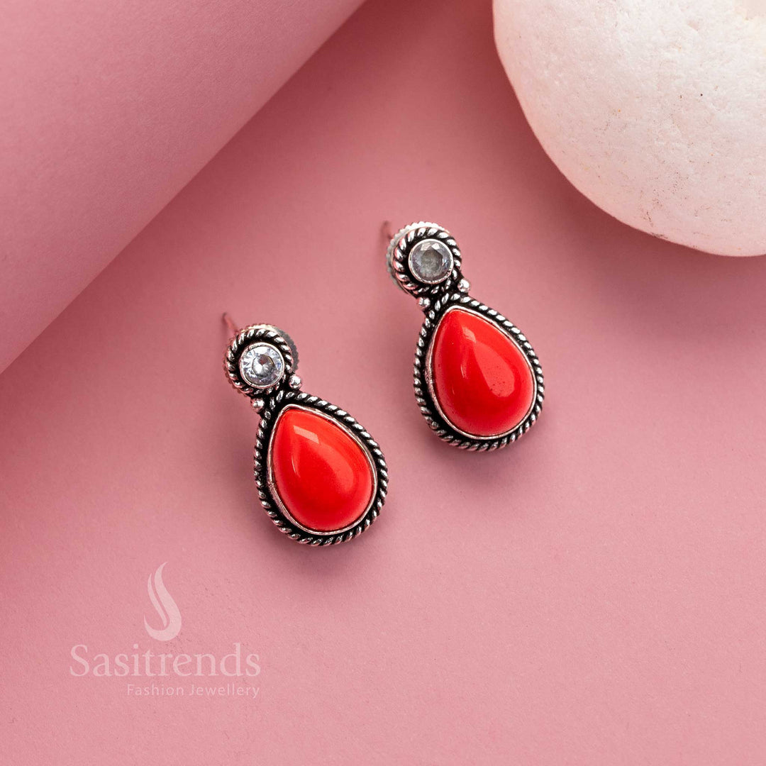 Bold red oxidised silver stud earrings featuring a striking Monalisa gem and shimmering AD stones – a vibrant festive jewellery choice for statement looks – Sasitrends