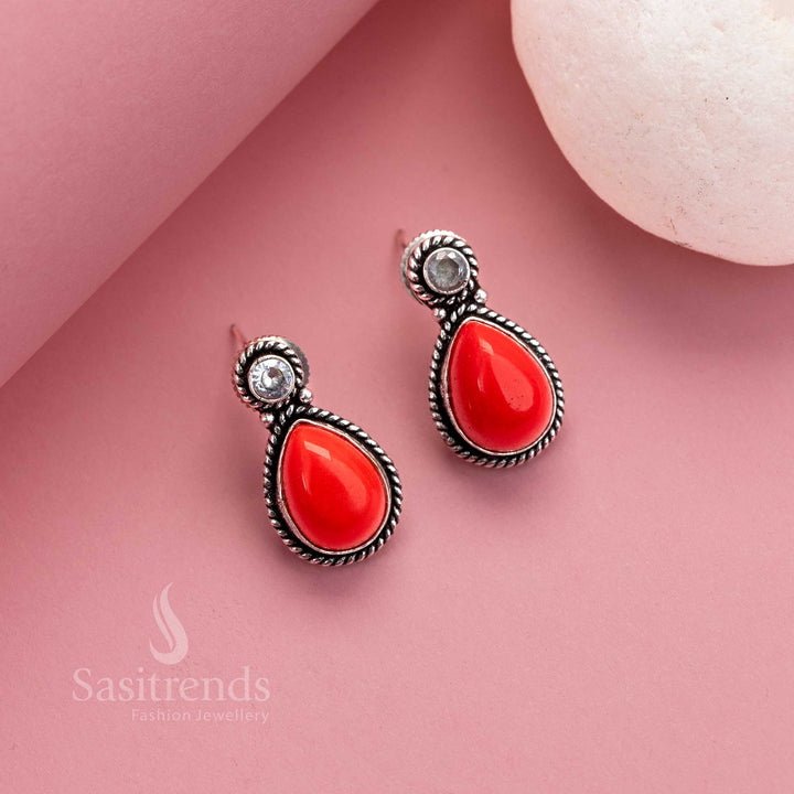 Bold red oxidised silver stud earrings featuring a striking Monalisa gem and shimmering AD stones – a vibrant festive jewellery choice for statement looks – Sasitrends