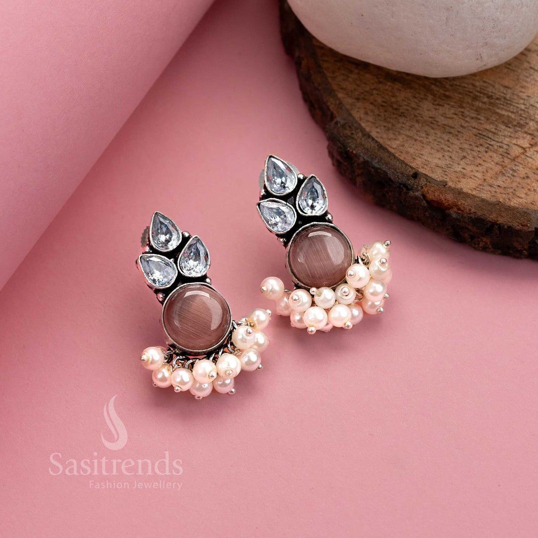 Soft peach-toned oxidised silver earrings with shimmering AD studs, Monalisa stone and pearl drop detail – graceful ethnic jewellery by Sasitrends