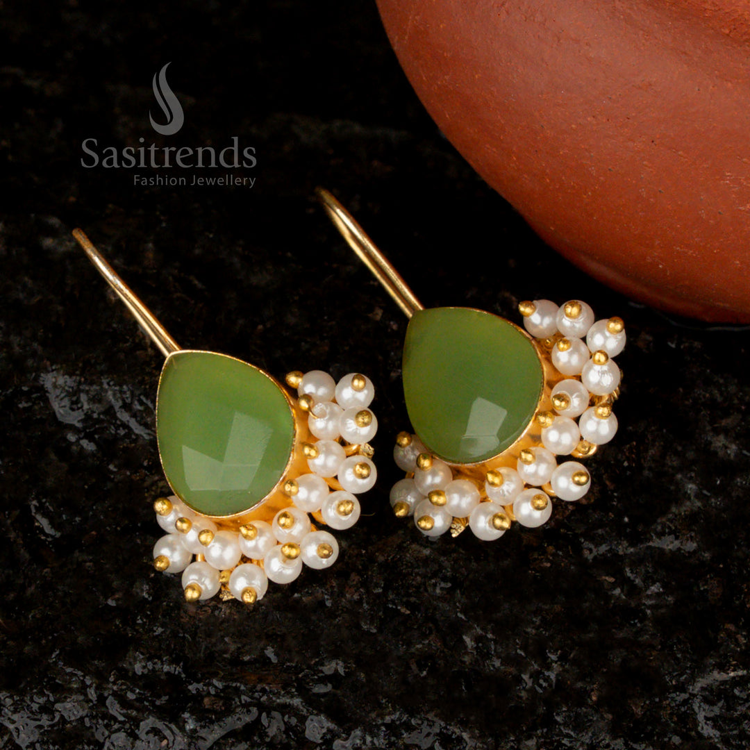 Elegant handcrafted gold-plated pear-shaped earrings featuring a mesmerizing mint Monalisa stone and dainty pearl embellishments for a graceful look