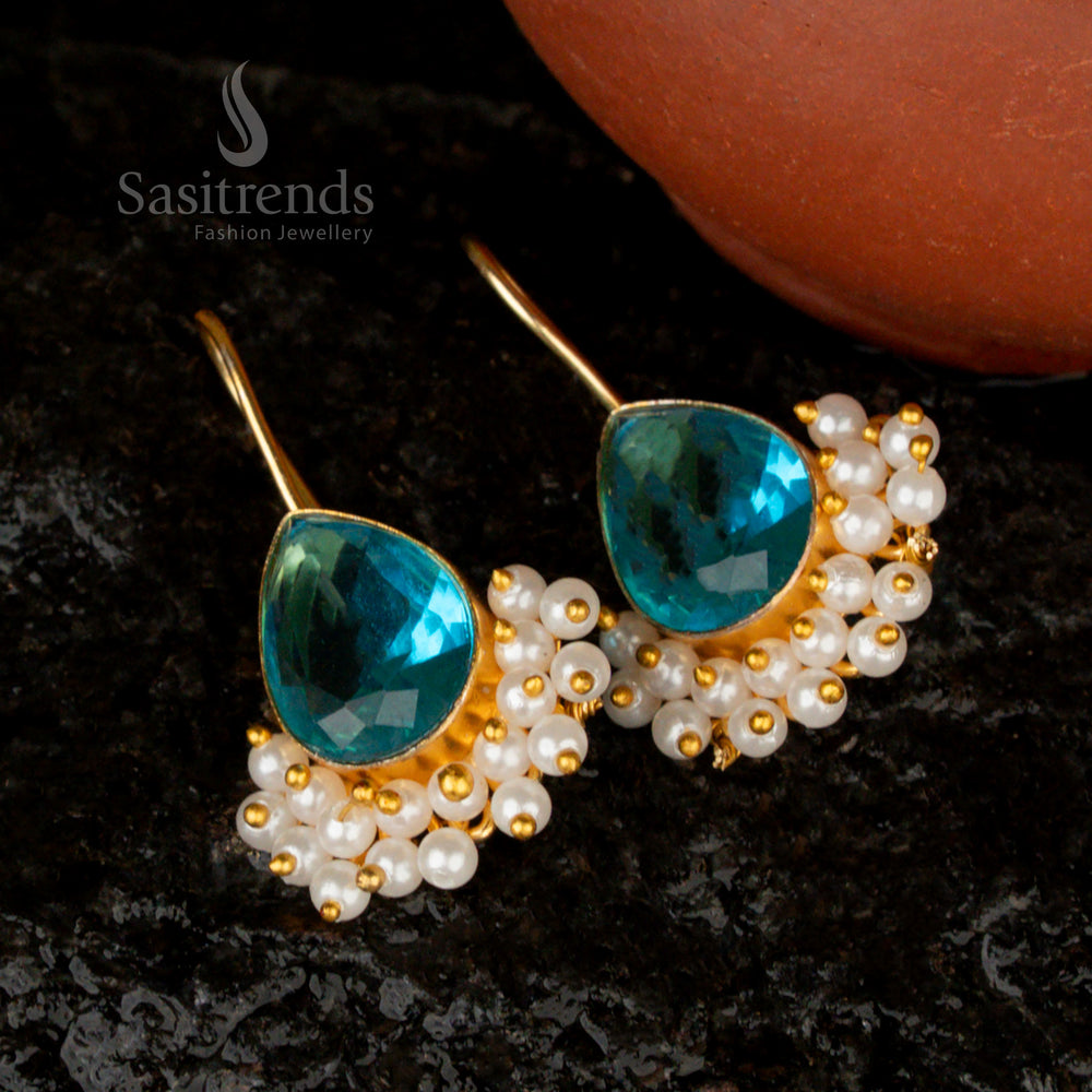 Serene and elegant sky-blue pear-shaped Monalisa stone earrings, gold-plated and adorned with pearls for a fresh, breezy appeal