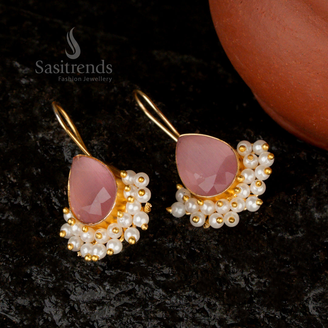 Elegant blush pink pear-shaped earrings, crafted with a Monalisa stone, pearls, and a radiant gold-plated design