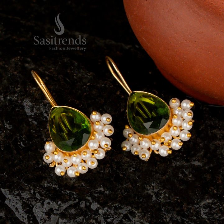 Glowing and artistic light-green Monalisa stone pear-shaped earrings with gold plating and pearl drops, radiating sophistication and charm