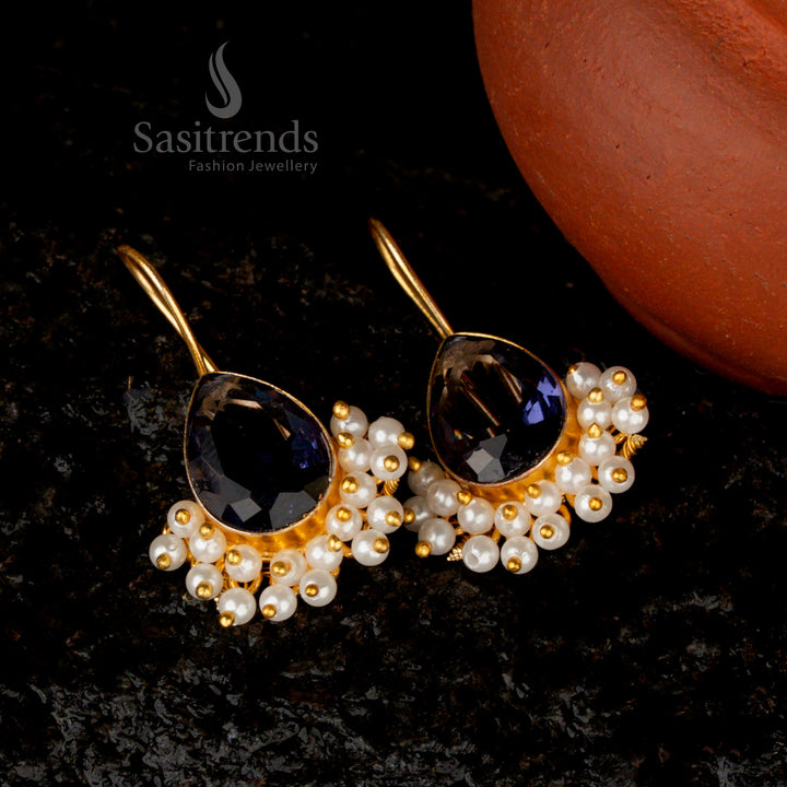 Lustrous violet Monalisa stone earrings in a pear-shaped design, elegantly finished with gold plating and pearl accents