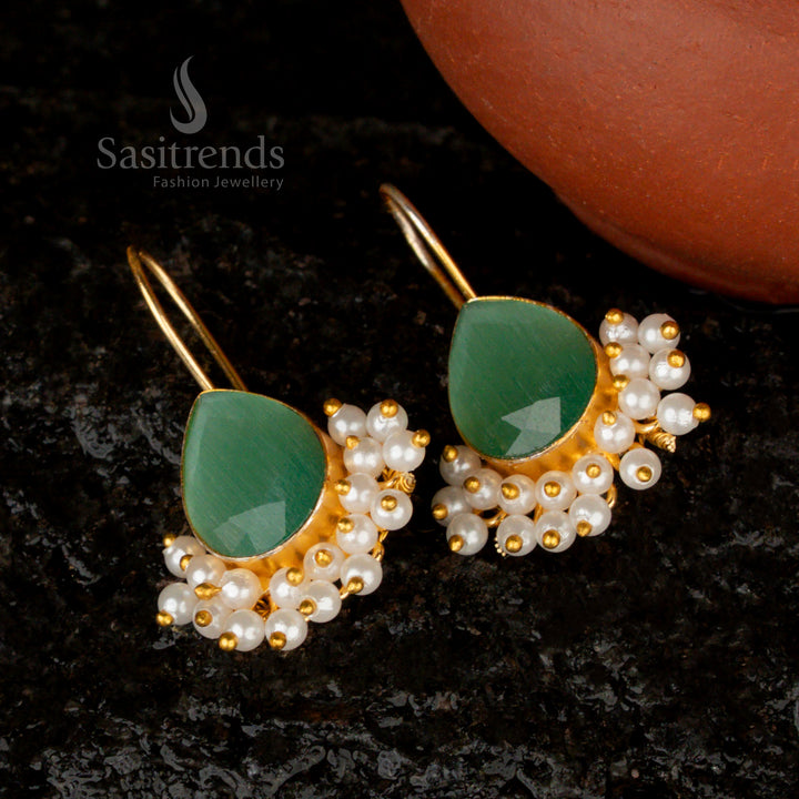 Elegant pastel  pear-shaped earrings featuring a Monalisa stone, pearls, and a delicate gold finish