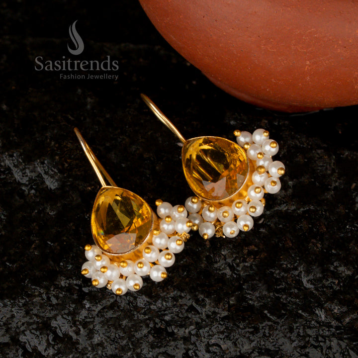 Bright and vibrant sunshine yellow pear-shaped earrings, adorned with a Monalisa stone, pearls, and a stunning gold-plated finish