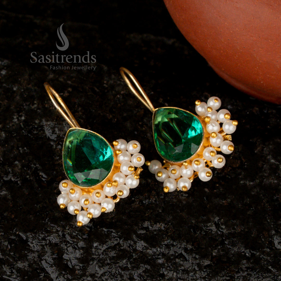 Regal deep emerald-green Monalisa stone earrings in a pear shape, complemented by pearls and a gleaming gold finish