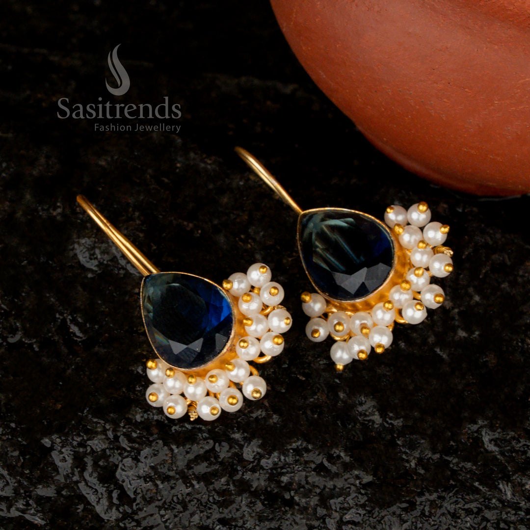 Deep and sophisticated dark-blue Monalisa stone earrings in a pear shape, enhanced with pearls and an exquisite gold finish